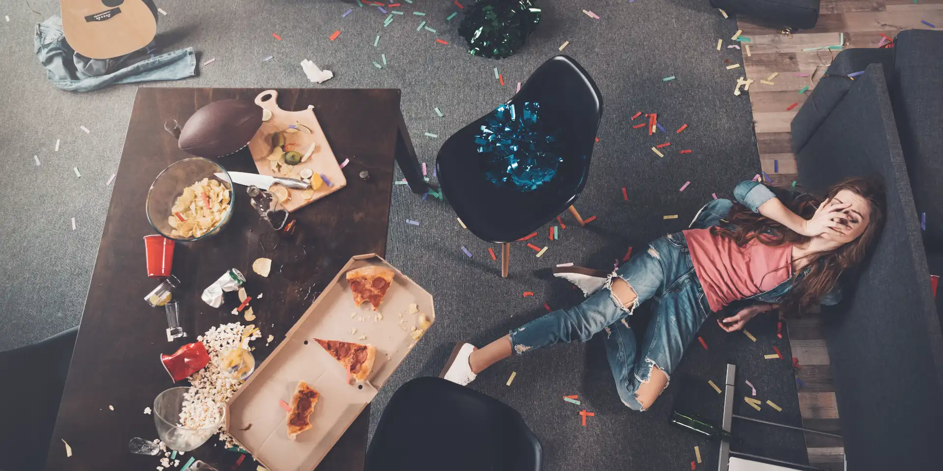 top view of young drunk woman lying on floor